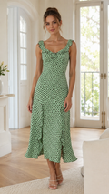 Front view of sage green polka dot midi dress with ruffle straps and sweetheart neckline