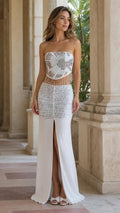 Front view of woman wearing white beaded strapless two-piece maxi dress