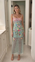 Front view of model wearing mint green embroidered floral sequin mesh midi dress