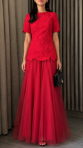 Front view of red floral textured short sleeve maxi evening dress with flowing tulle skirt