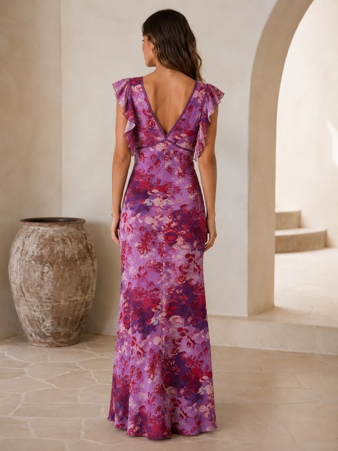 Back view of purple floral ruffle sleeve plunge maxi dress with low V back