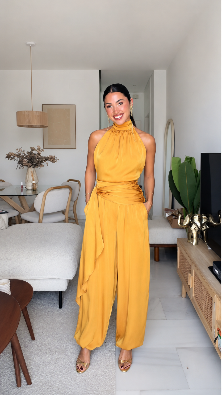 Front view of mustard halter neck wide leg jumpsuit with draped waist and pockets