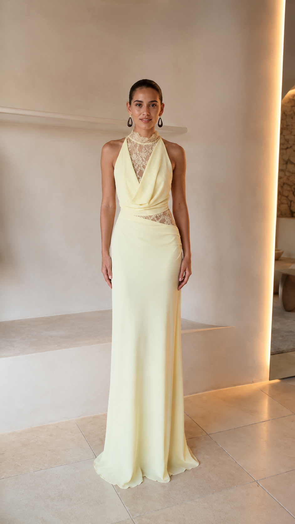 Front view of butter yellow halter evening gown with lace chest panel and floor-length skirt