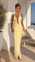 Front view of butter yellow plunging halter backless draped maxi dress