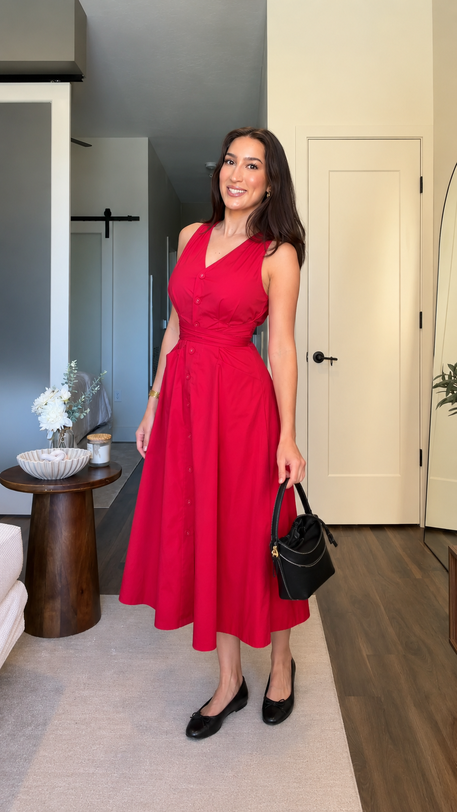 Front view of red sleeveless V-neck midi dress with button front and tie waist