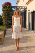 Front view of woman wearing white corset top and lace midi skirt set