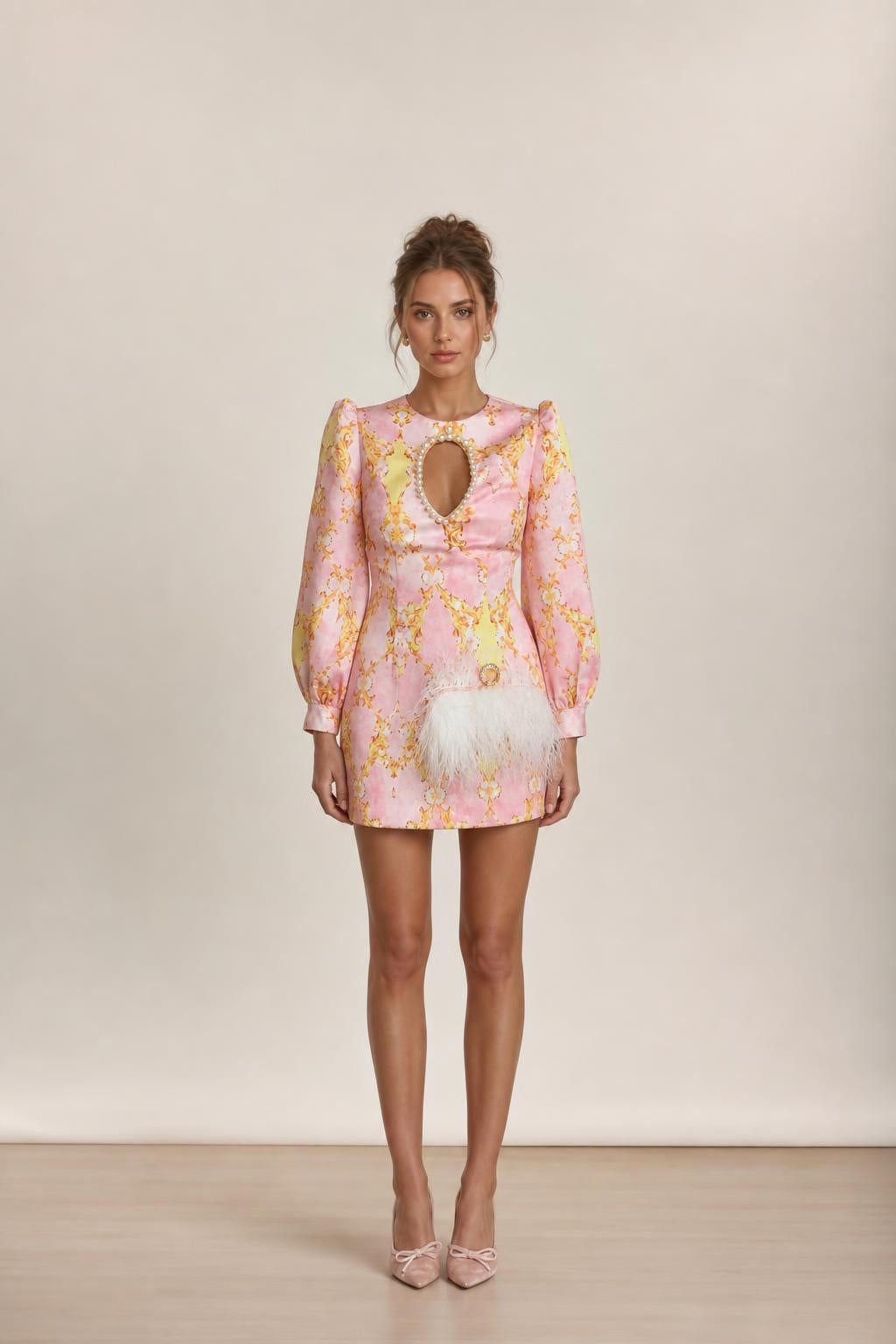Front view of model wearing pink baroque print mini dress