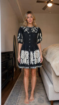 Front view of black boho embroidered mini dress