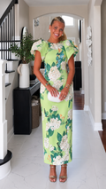 Front view of lime green floral maxi dress with ruffle sleeves and round neckline