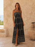 Black strapless printed maxi dress with front slit shown from the front