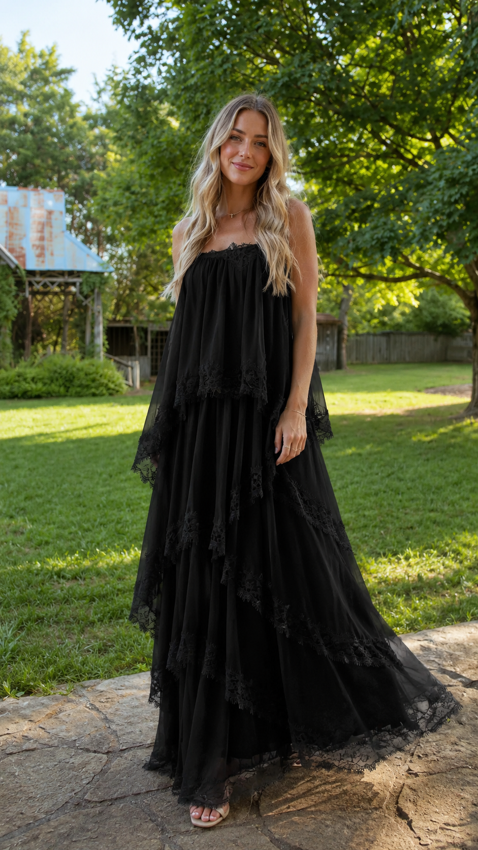 Black tiered lace trim maxi dress with spaghetti straps and flowy skirt front view