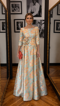 Front view of aqua and peach floral jacquard floor-length evening gown with boat neckline and waist rosette