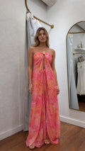 Model wearing pink boho halter maxi dress from the front