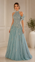 Front view of dusty blue embellished halter evening gown with floral shoulder detail