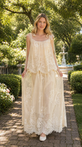 Front view of champagne tie-shoulder lace overlay maxi dress with sheer flowing skirt