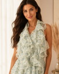 Close-up of sage floral ruffle halter mini dress with layered front detail
