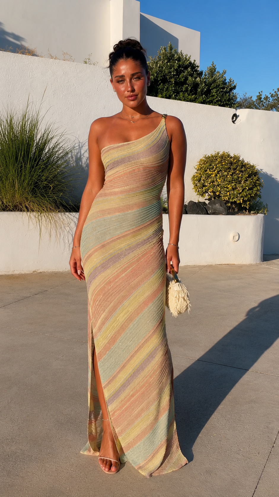 Front view of pastel striped one-shoulder textured maxi dress with side slit