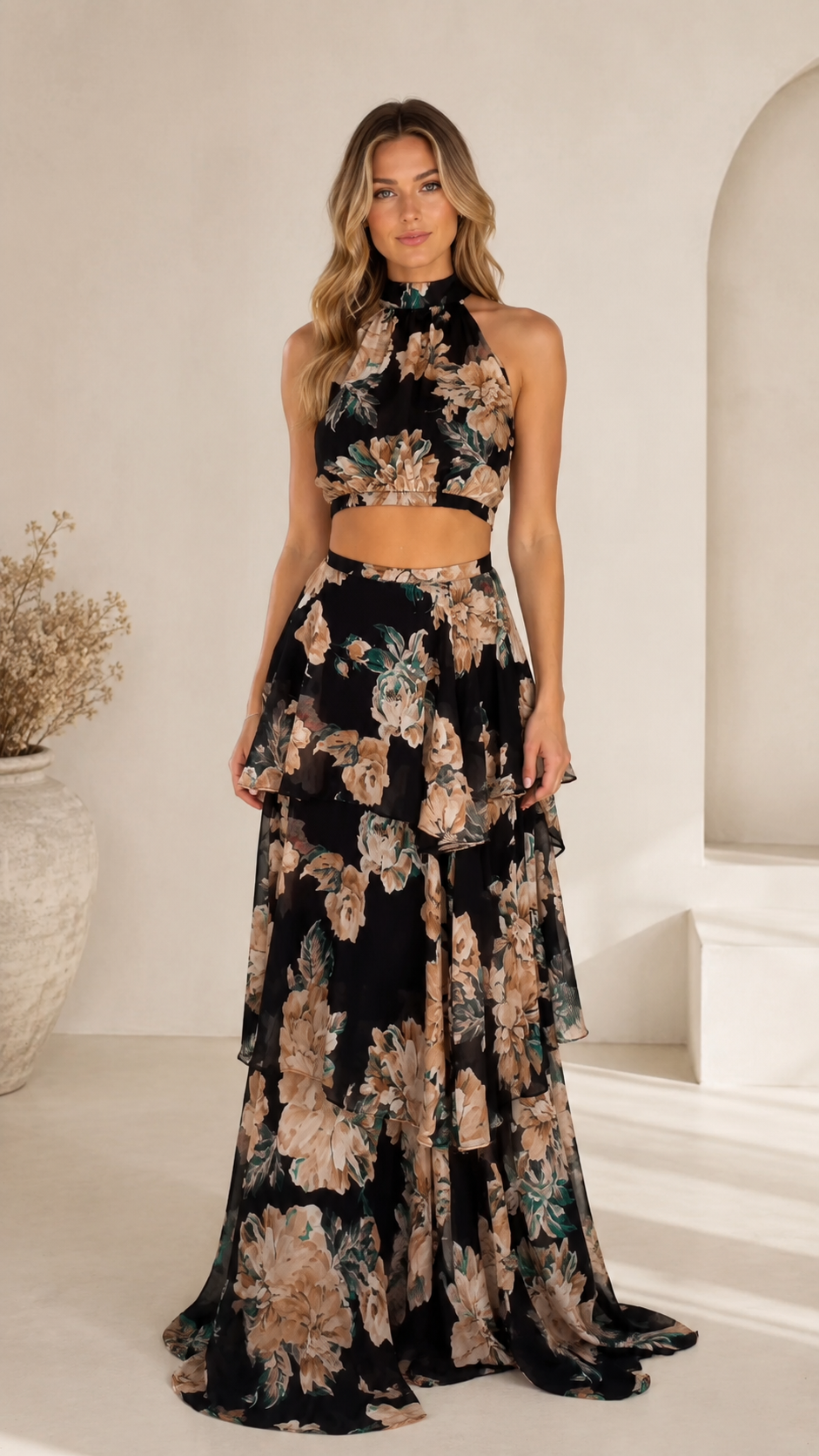 Front view of black floral halter crop top and tiered maxi skirt two-piece dress set