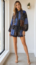 Front view of model wearing black multi paisley long sleeve romper