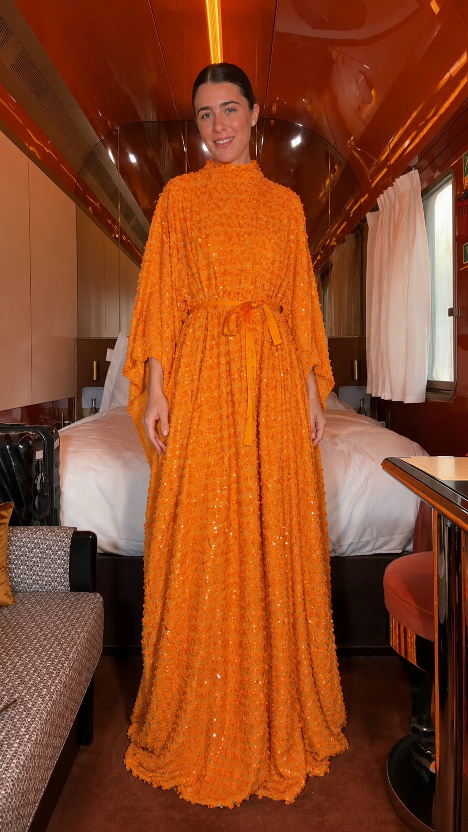 Front view of orange textured sequin belted maxi caftan dress with high neck