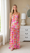 Front view of pink floral strapless drop-waist maxi dress with ruffle hem
