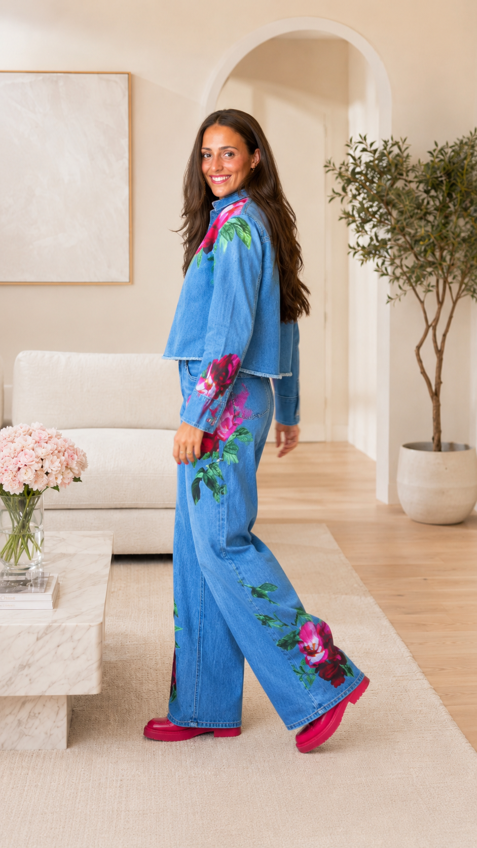 Side view of light blue floral print denim jacket and wide leg jeans set