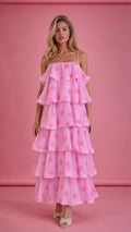 Front view of model wearing pink polka dot tiered ruffle midi dress