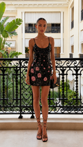 Front view of black sequin floral spaghetti strap mini dress
