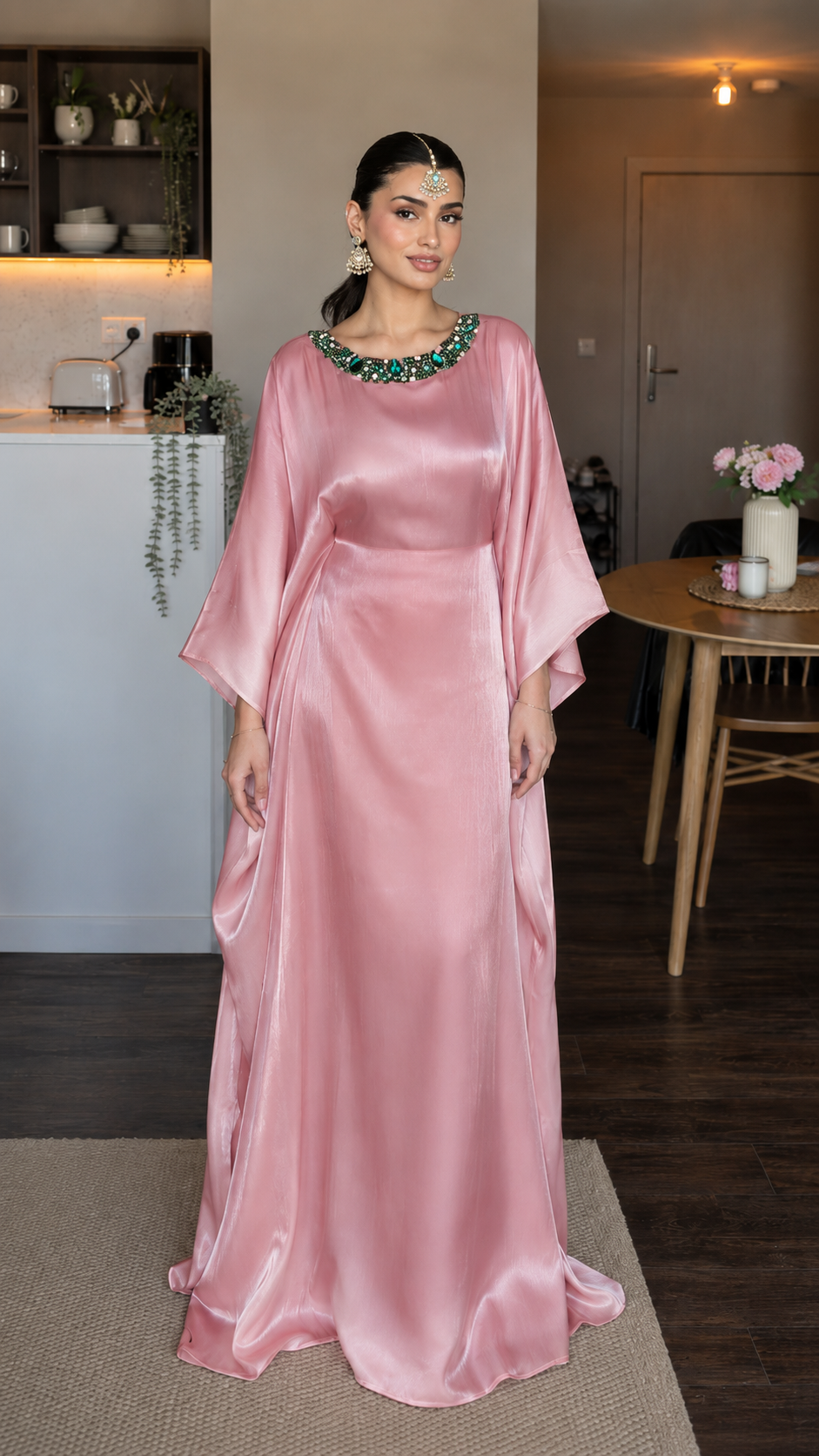 Front view of blush pink satin-look maxi dress with embellished round neckline and floor-length silhouette