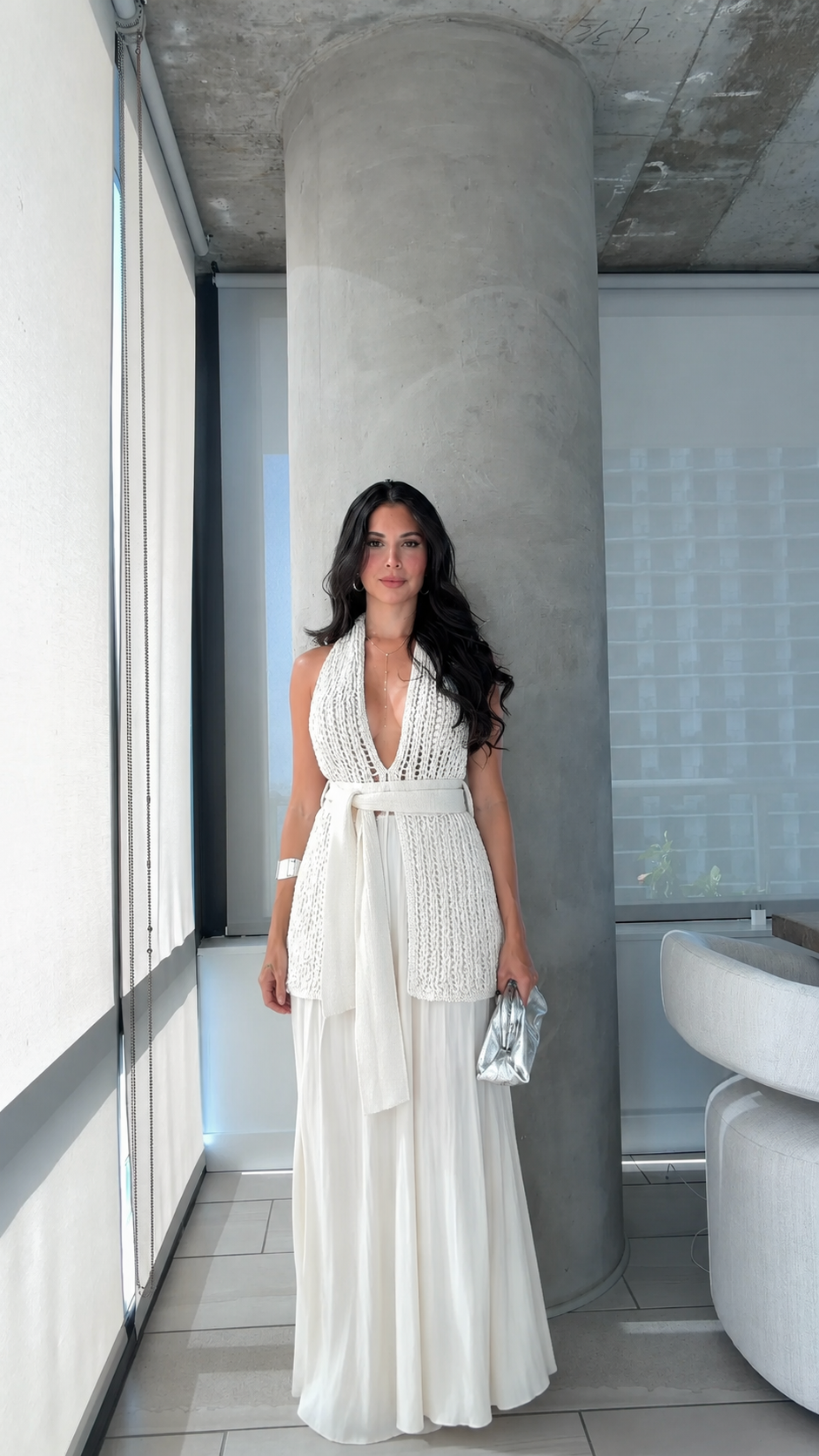 Front view of ivory plunging halter maxi dress with flowing full-length skirt