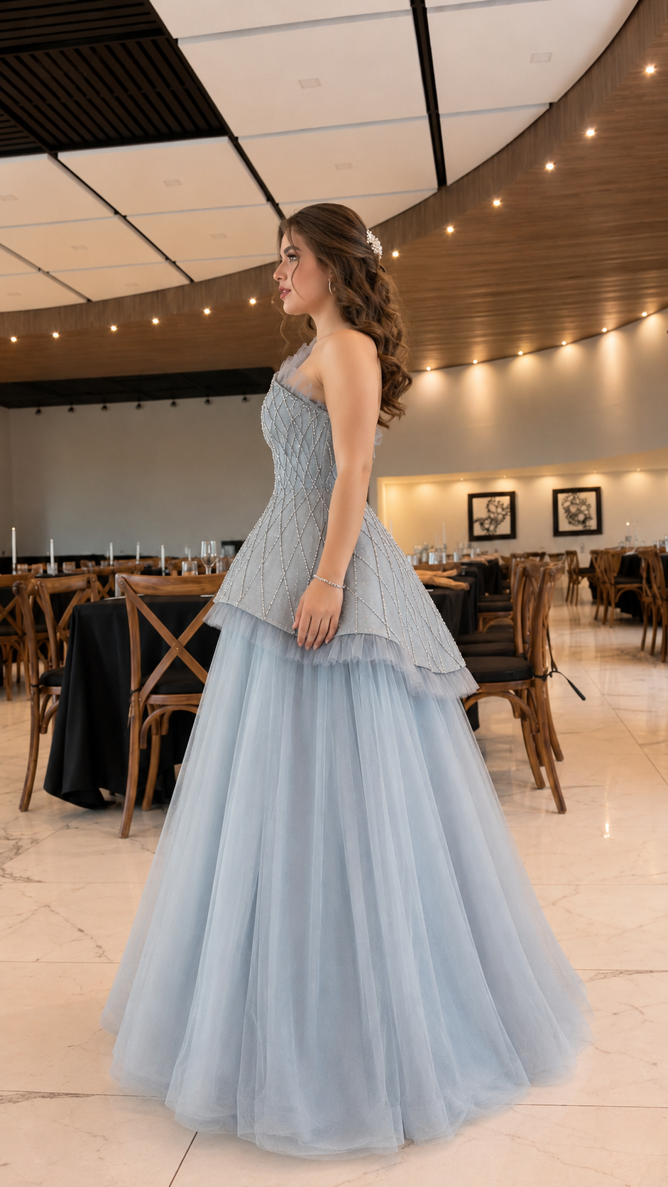 Side view of dusty blue asymmetrical evening gown with fitted embellished bodice