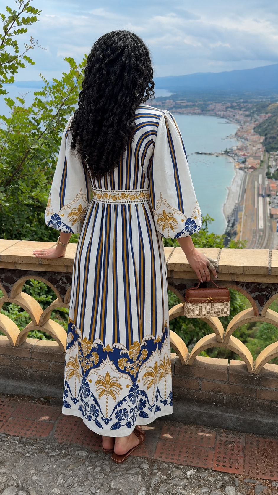 Back view of white bohemian print maxi dress with vertical stripes and ornate hem border