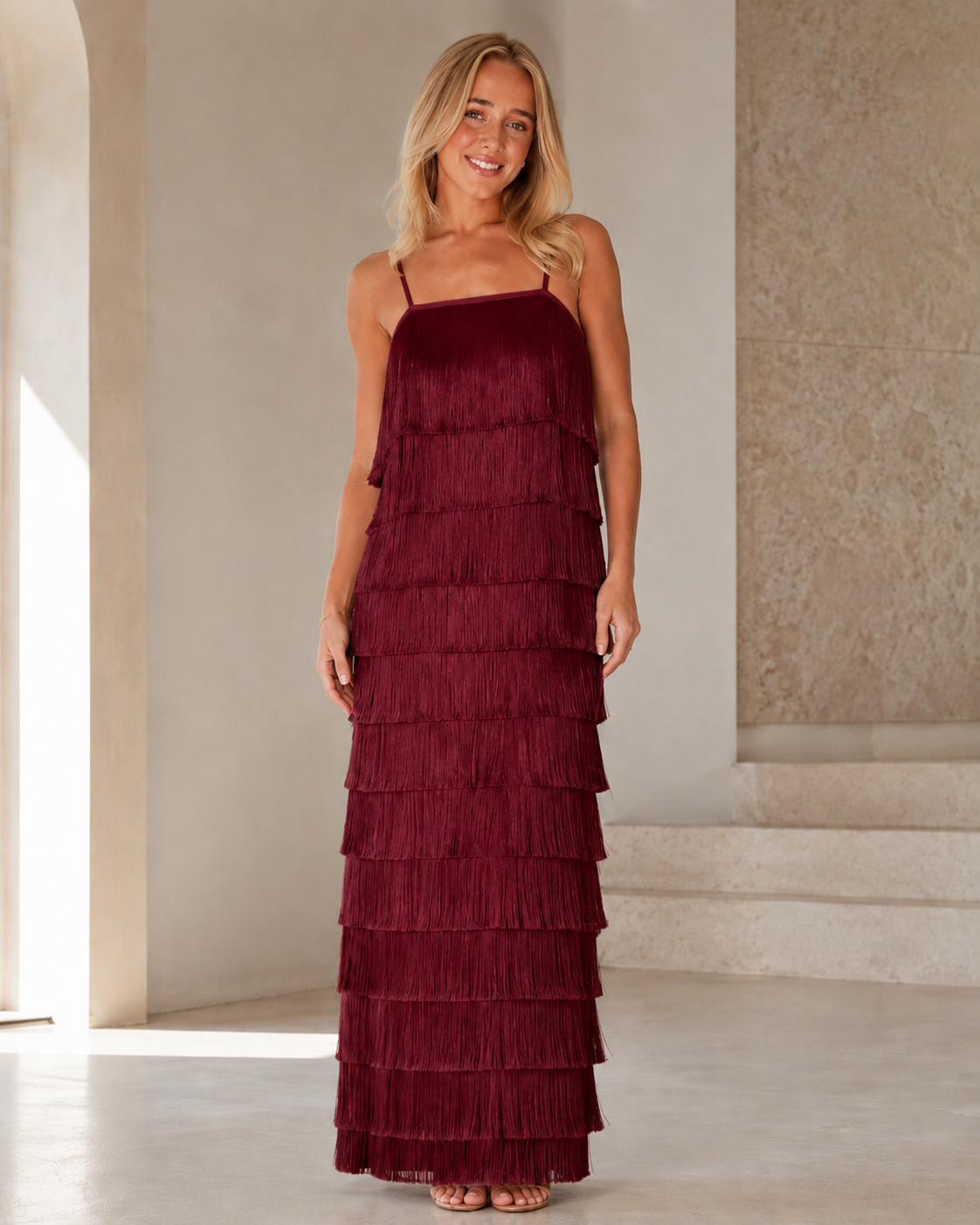 Full front view of burgundy tiered fringe maxi dress with sleeveless cami straps