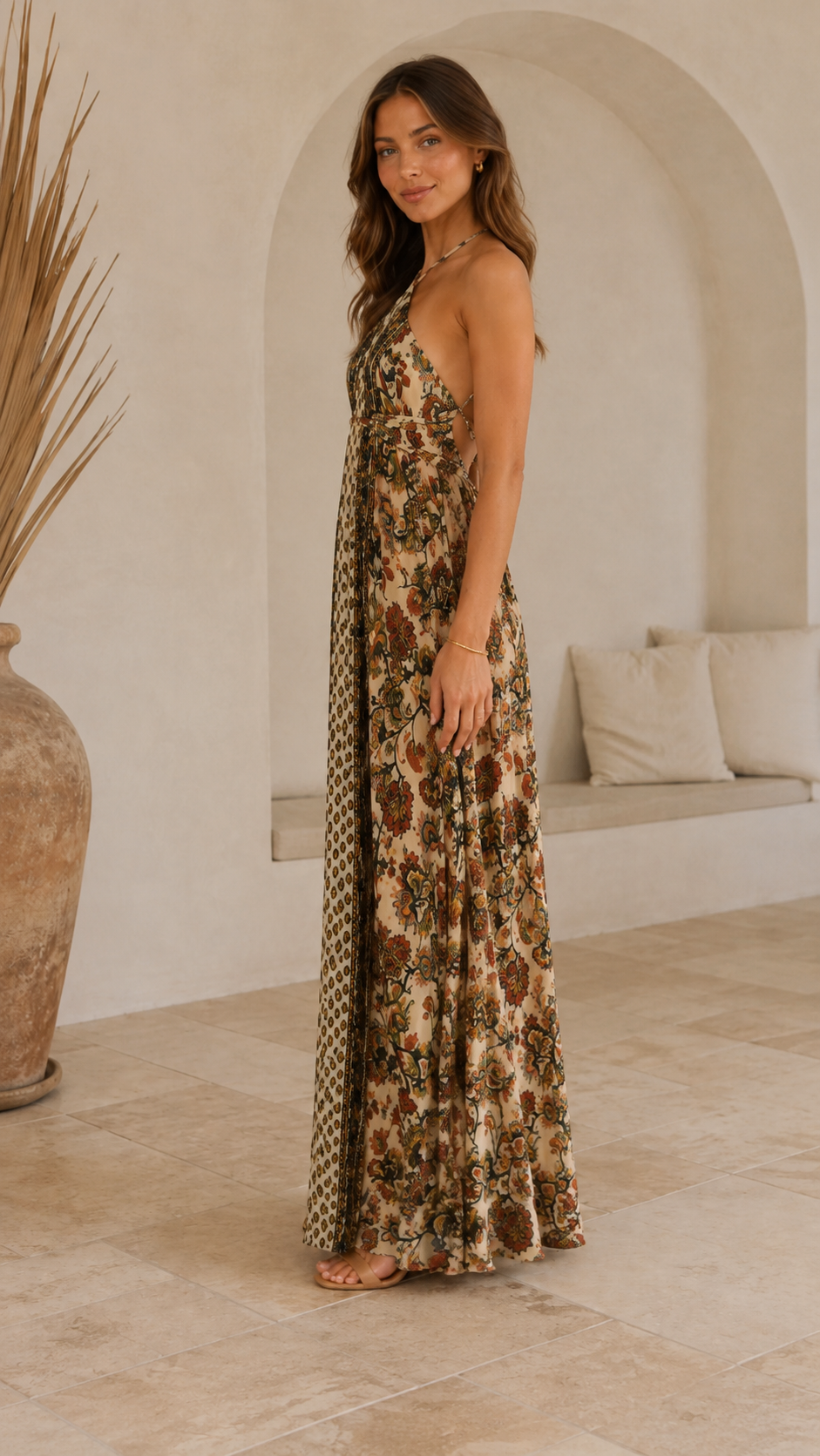 Side view of beige halter maxi dress with flowing full-length skirt