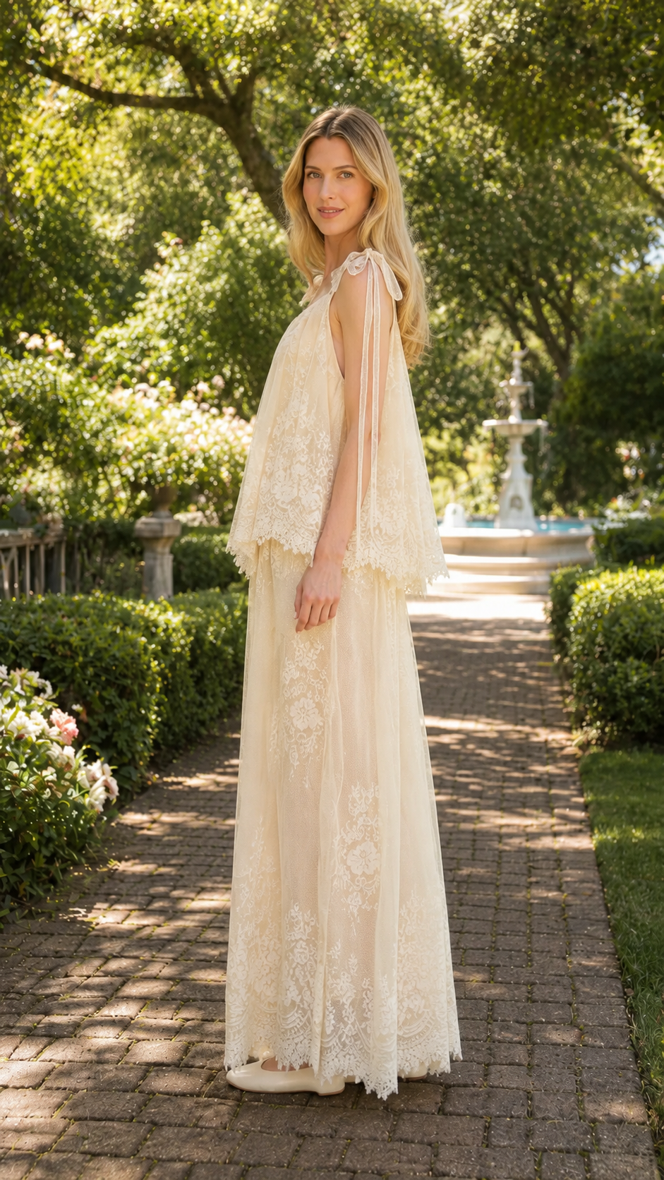 Side view of champagne sleeveless lace maxi dress with layered overlay and tie straps