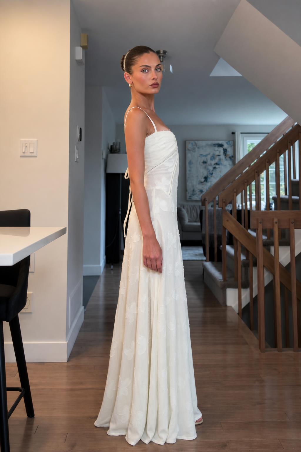 Side profile of woman in white maxi dress