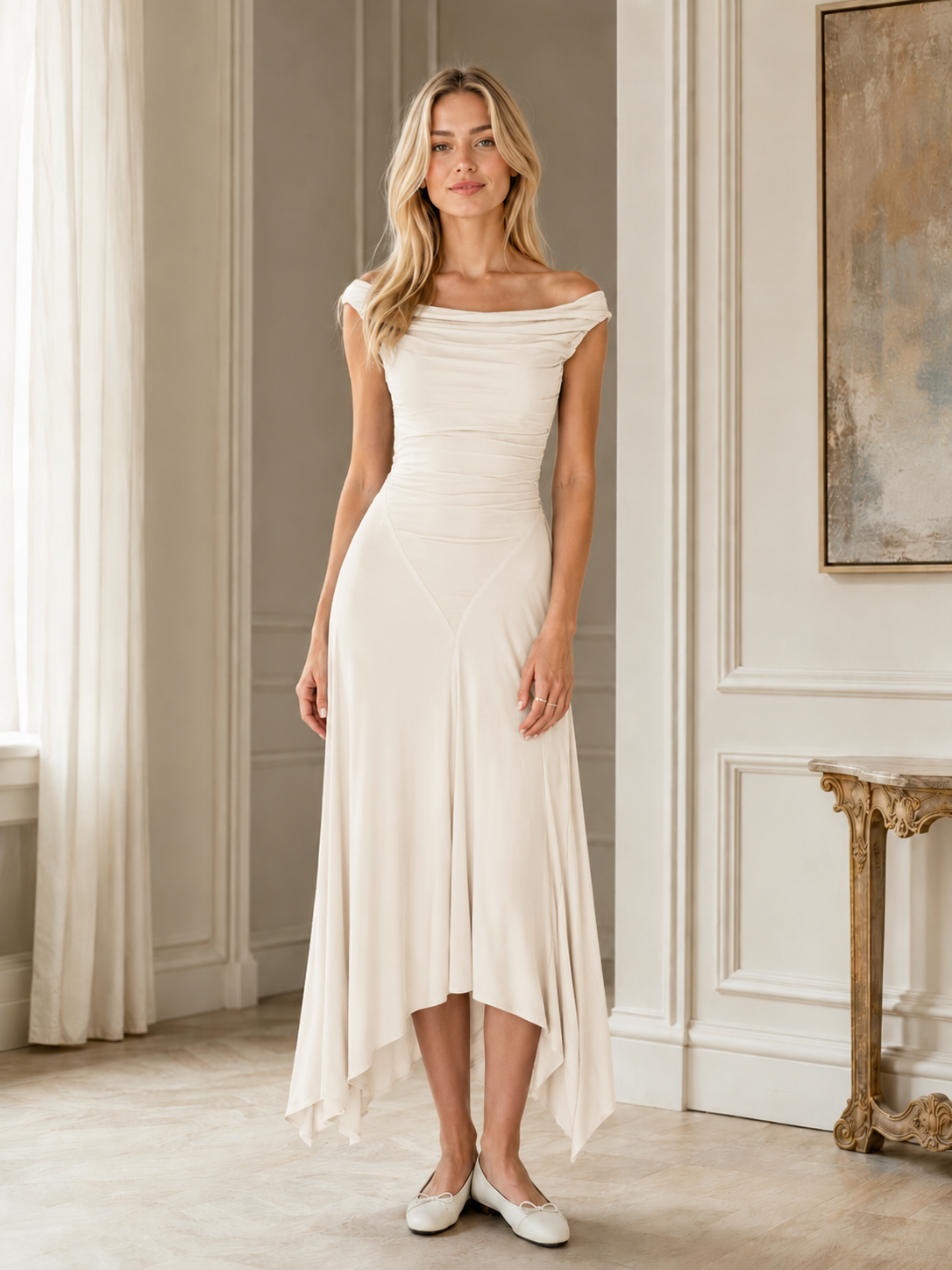 Front view of ivory off-shoulder ruched handkerchief hem dress