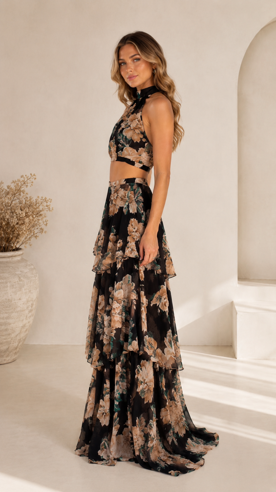 Side view of black floral halter two-piece maxi dress set with layered skirt