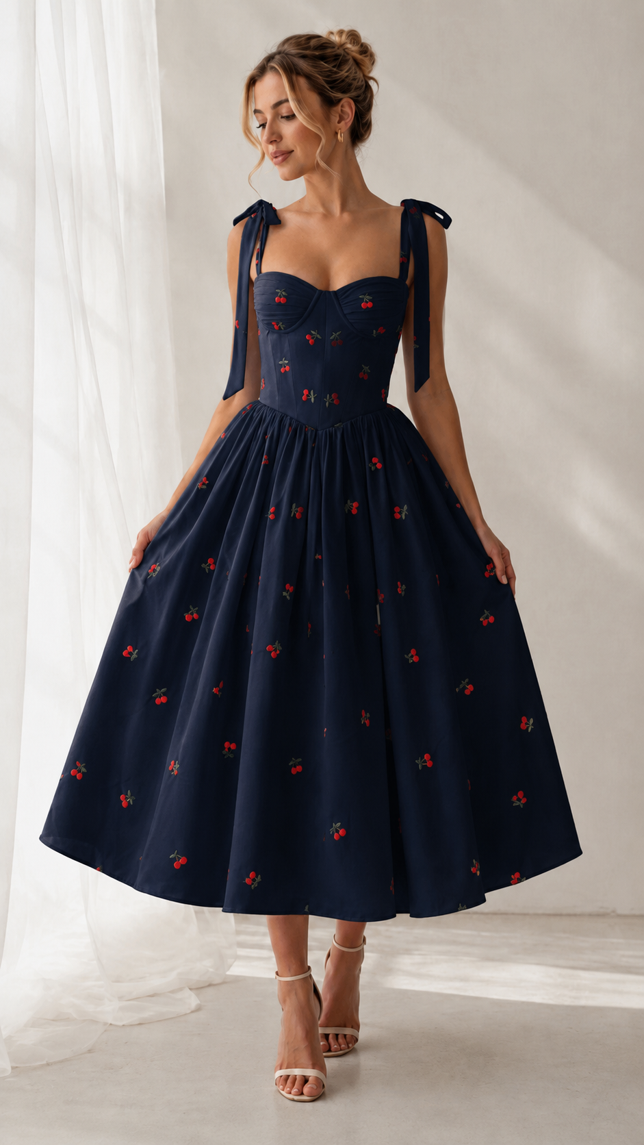 Front view of navy cherry print tie-strap sweetheart midi dress with full skirt