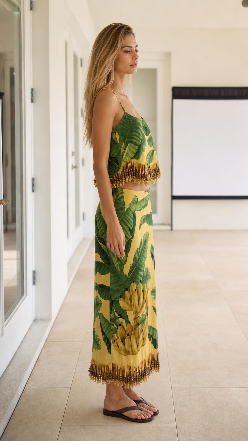 Side profile view of model wearing the yellow tropical two-piece skirt set
