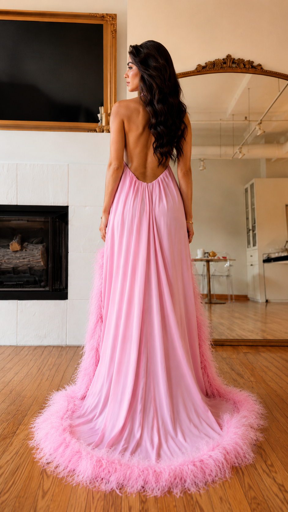 Back view of pink halter maxi dress with low open back and feathered train hem