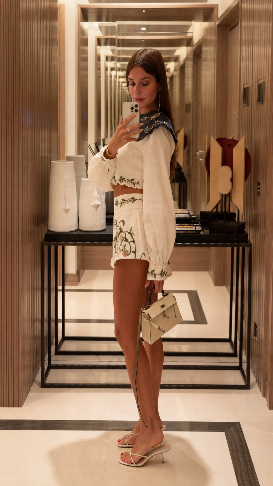 Side view of ivory long-sleeve crop blouse and embroidered shorts matching set