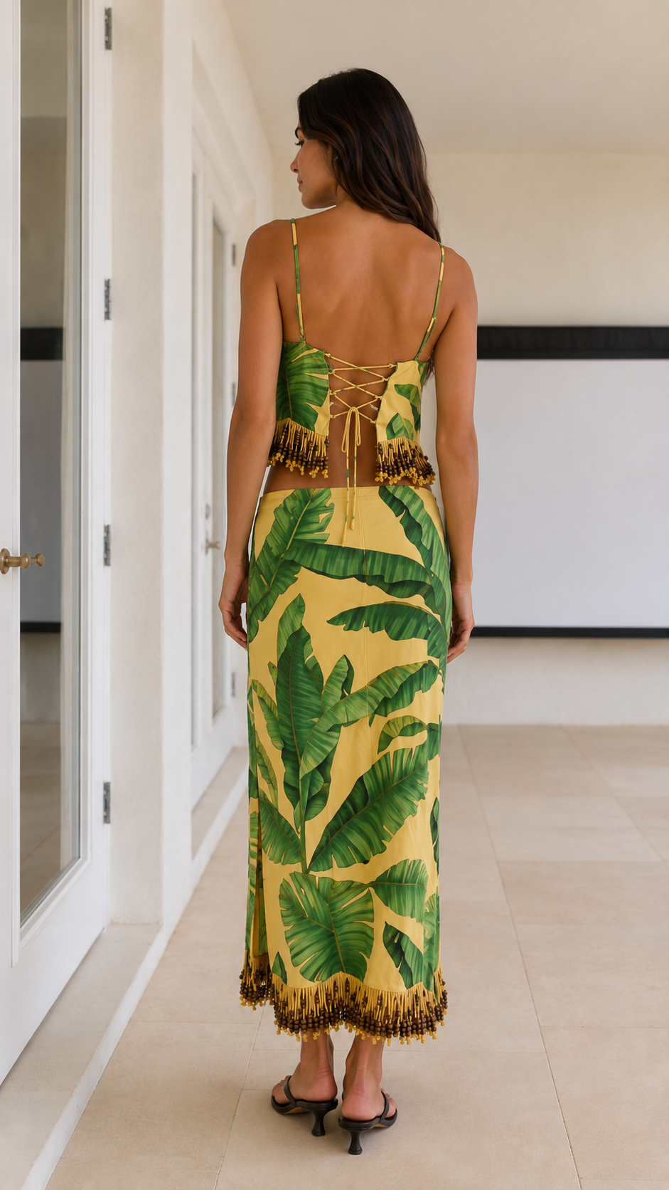 Back view of yellow tropical print set with lace-up back detail and fringe trim