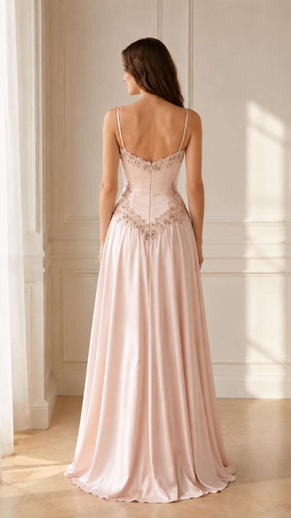 Back view of blush pink embroidered spaghetti strap formal gown