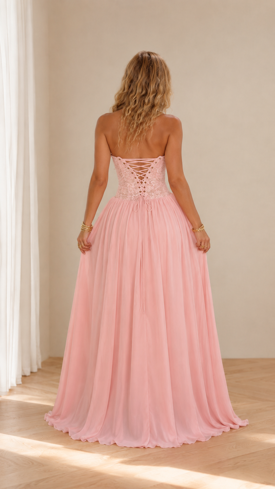 Back view of blush pink gown with lace-up corset back and maxi skirt
