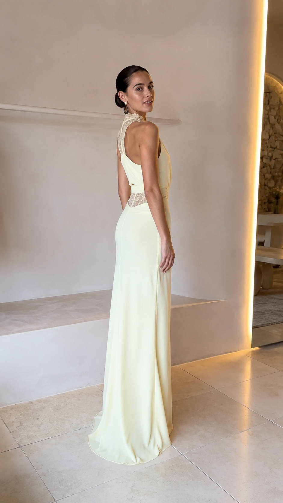 Back view of butter yellow sleeveless evening gown with open back and lace detail