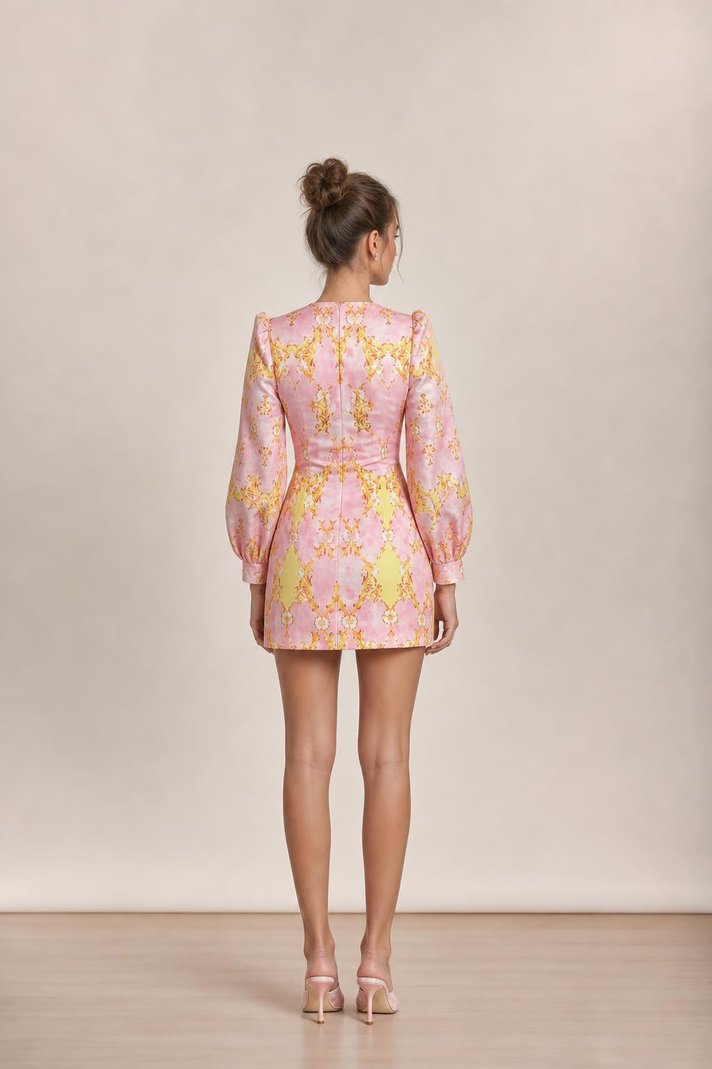 Back view of model showing tailored seams of pink dress