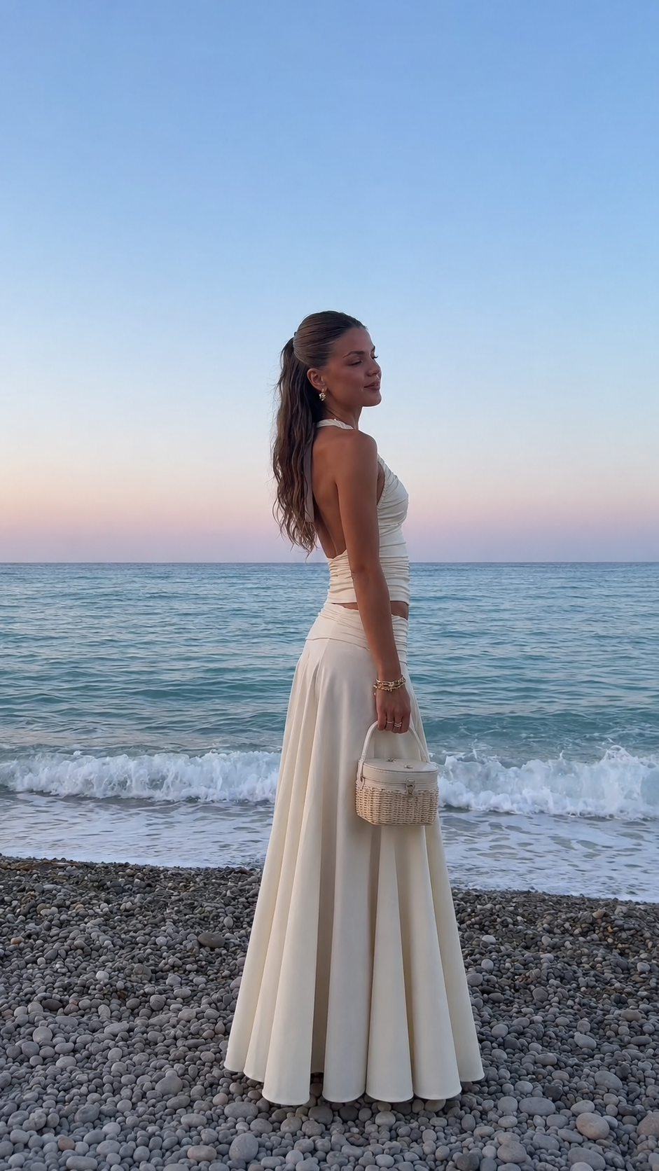 Side view of ivory open-back halter top with full maxi skirt