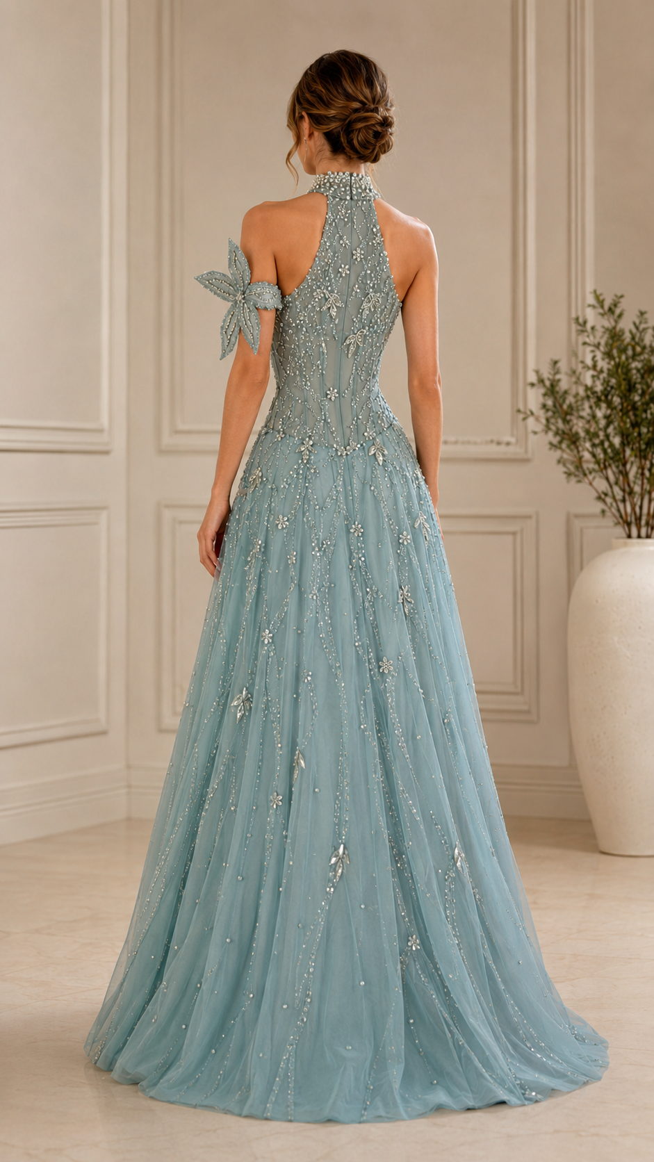Back view of dusty blue halter evening dress with full skirt and floral shoulder accent