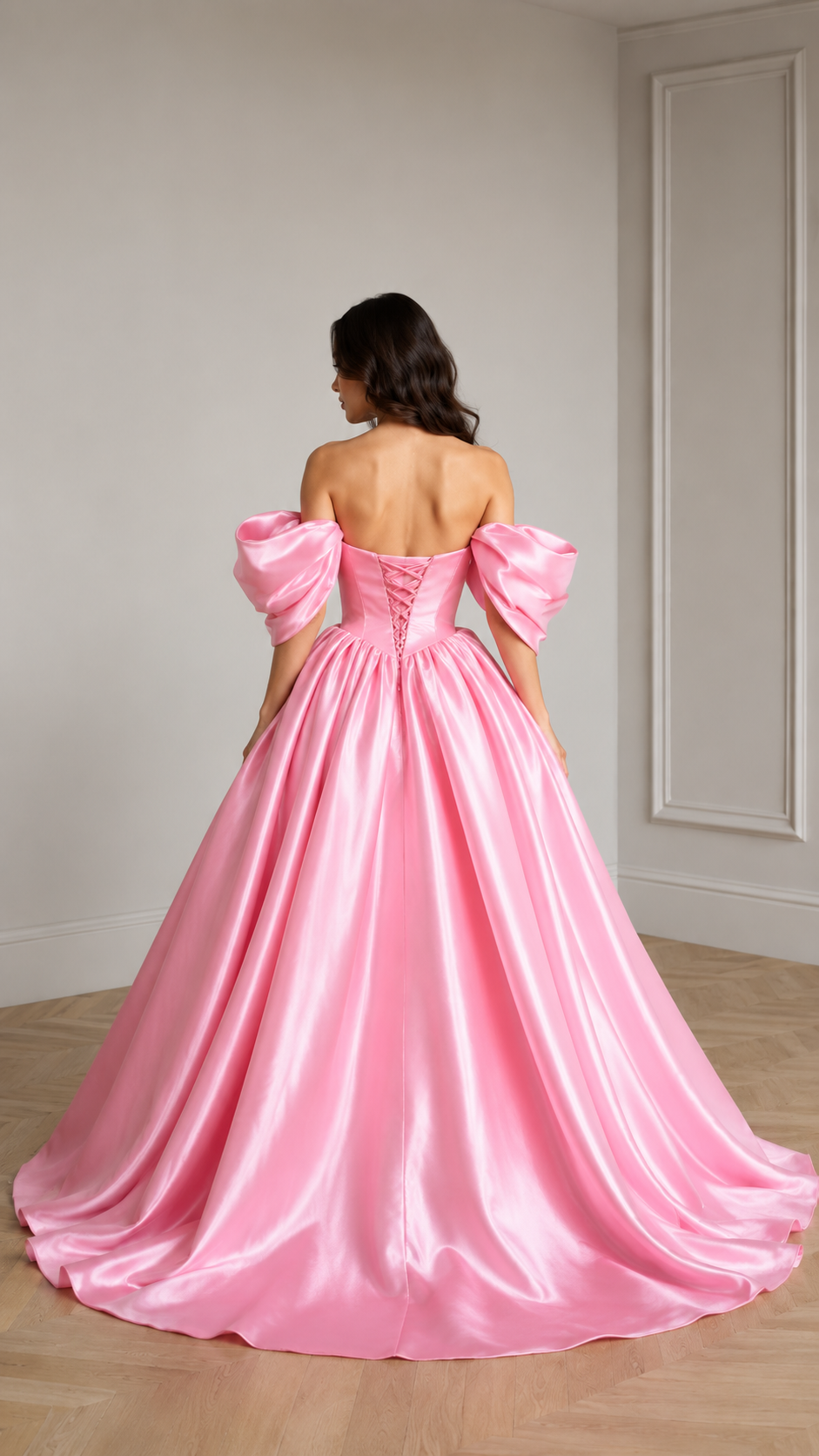 Back view of pink off-shoulder ball gown showing lace-up back and full train-like hem